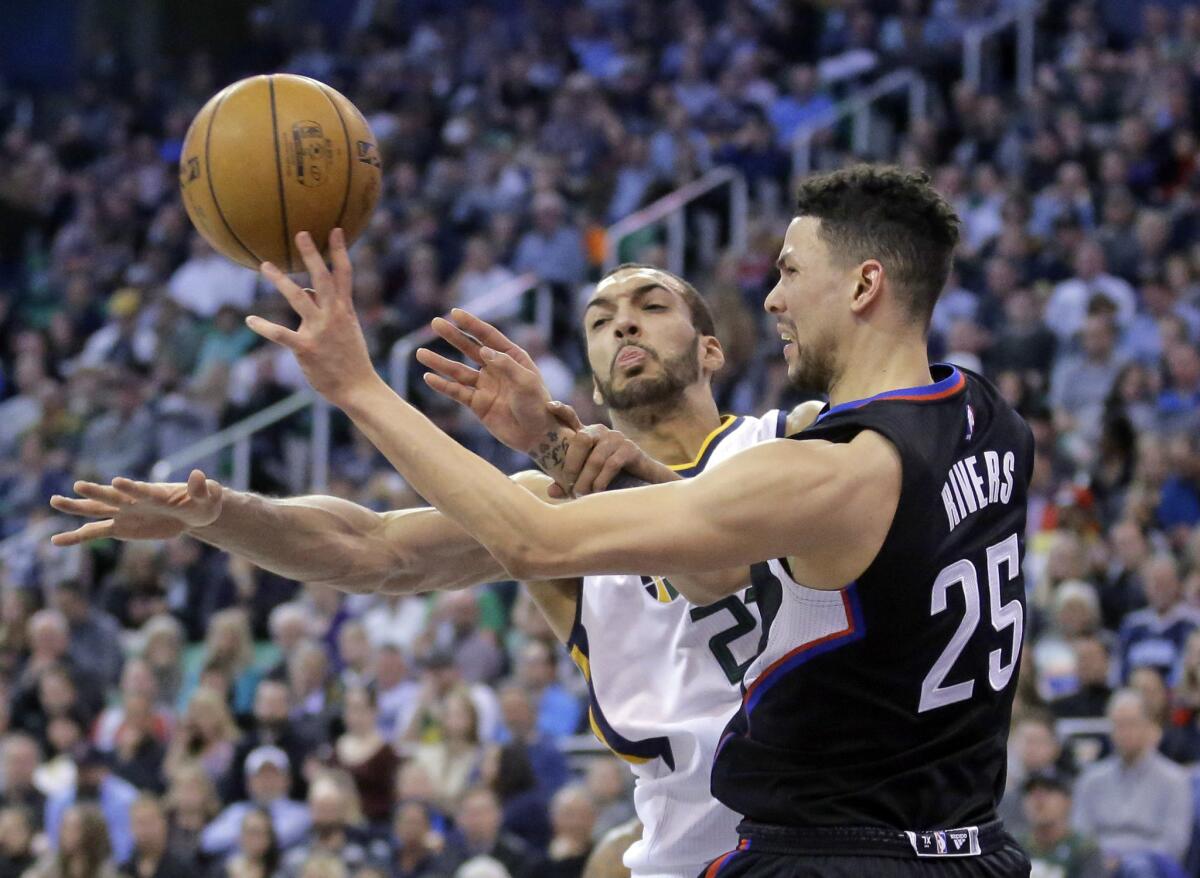 Clippers guard Austin Rivers tries to get the ball past Utah center Rudy Gobert on Feb. 13.