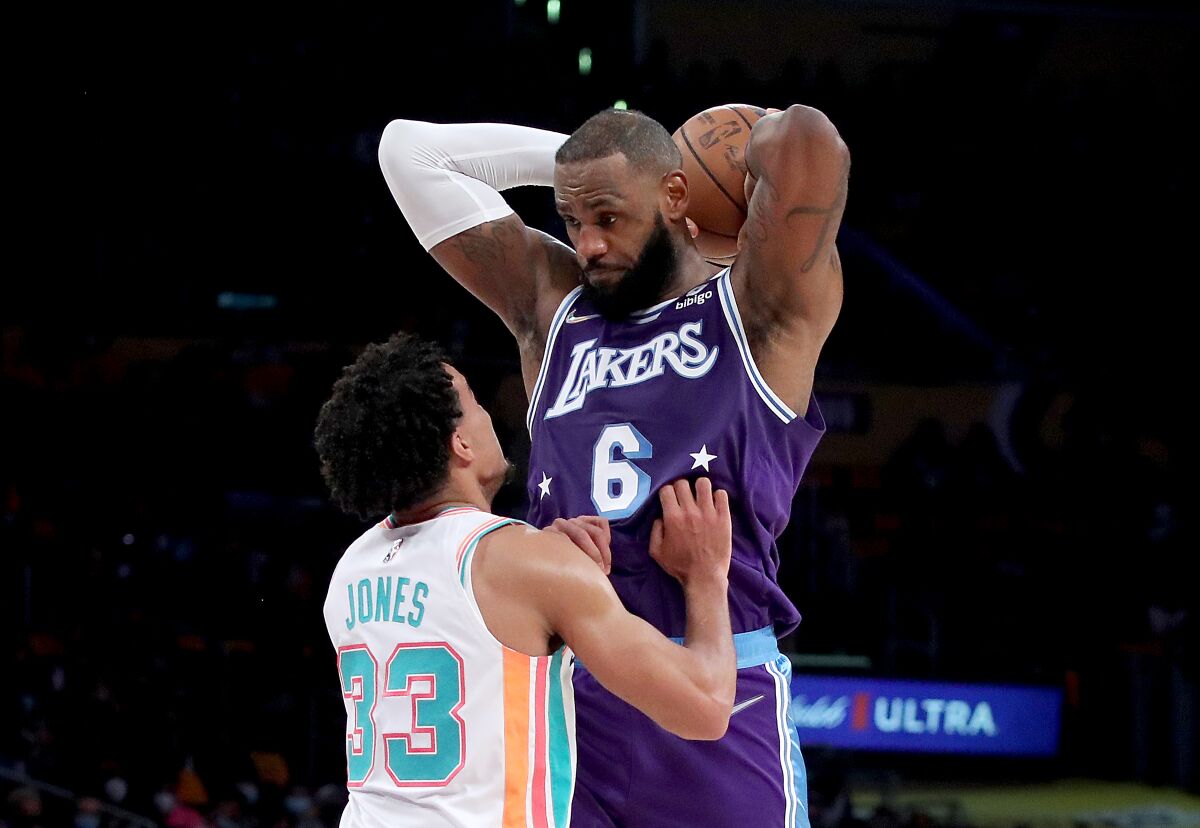 Lakers forward LeBron James posts up against San Antonio Spurs guard Tre Jones.