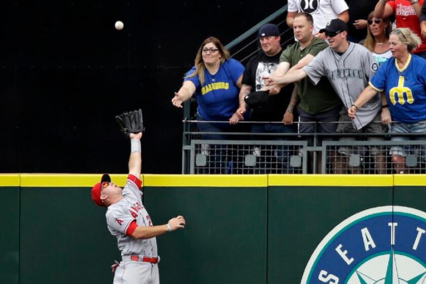 Angels outfielder Mike Trout goes up to rob the Mariners' Leonys Martin of a grand slam during a game in Seattle on Aug. 7, Trout's 25th birthday.