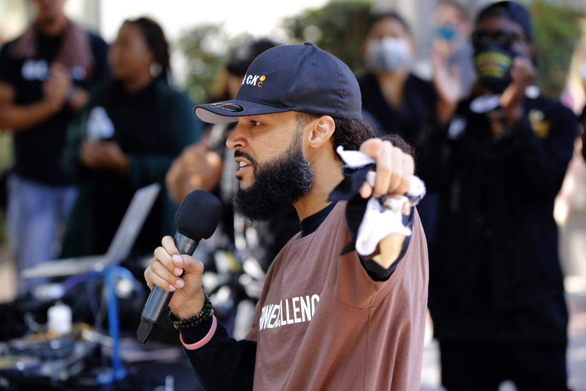 Ferin Kidd, organizer and executive director of Black O.C., speaks during the Juneteenth event at Sasscer Park.