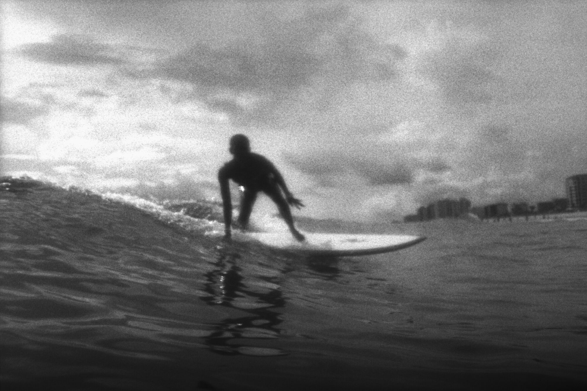 A black and white image of a surfer.