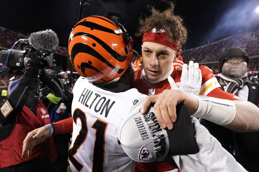 Cincinnati Bengals cornerback Mike Hilton (21) speaks with Kansas City Chiefs quarterback Patrick Mahomes after the NFL AFC Championship playoff football game, Sunday, Jan. 29, 2023, in Kansas City, Mo. The Chiefs won 23-20. (AP Photo/Charlie Riedel)