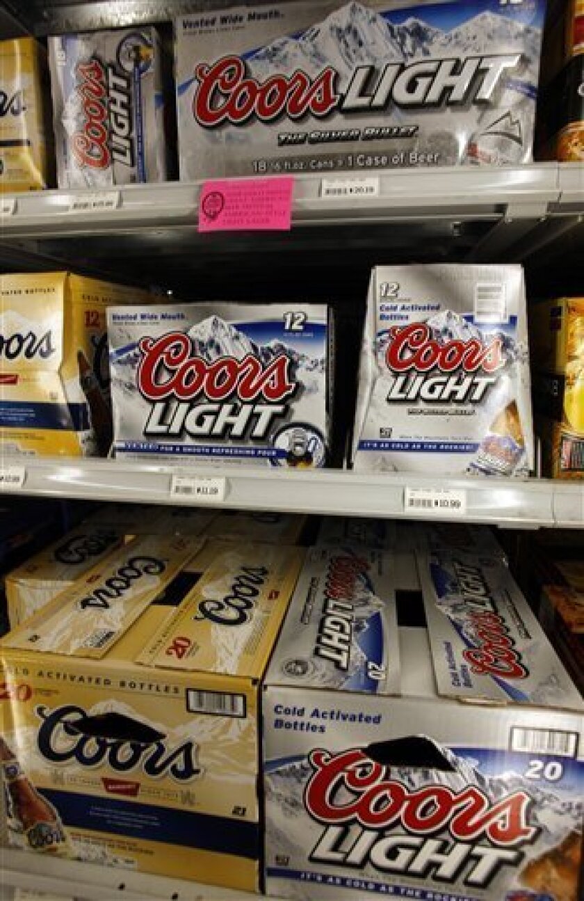 Packages of Coors and Coors Light beer chill on shelves in a liquor store in southeast Denver on Monday, Nov. 3, 2008. Brewer Molson Coors said Wednesday, its third-quarter profit rose 28 percent, but that result missed analysts' expectations. (AP Photo/David Zalubowski)