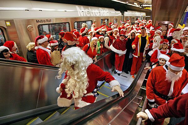 Revelers in Santa Claus costumes crowd into a Metro stop in Los Angeles on Saturday for SantaCon 2009. Hundreds participated in L.A. as part of an international event that began in San Francisco in 1994 and is intended to spread cheer and goodwill. The Santas assembled at the Empress Pavilion in Chinatown before heading out to various Metro stops.