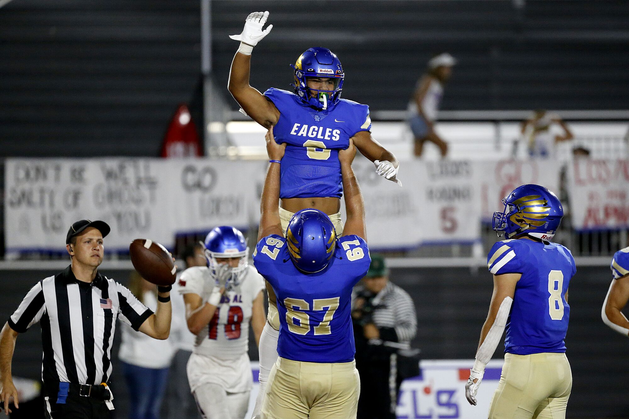 Santa Margarita tight end Nicholas Lopez is hoisted up in the air by Kilian O'Connor after catching a touchdown pass.
