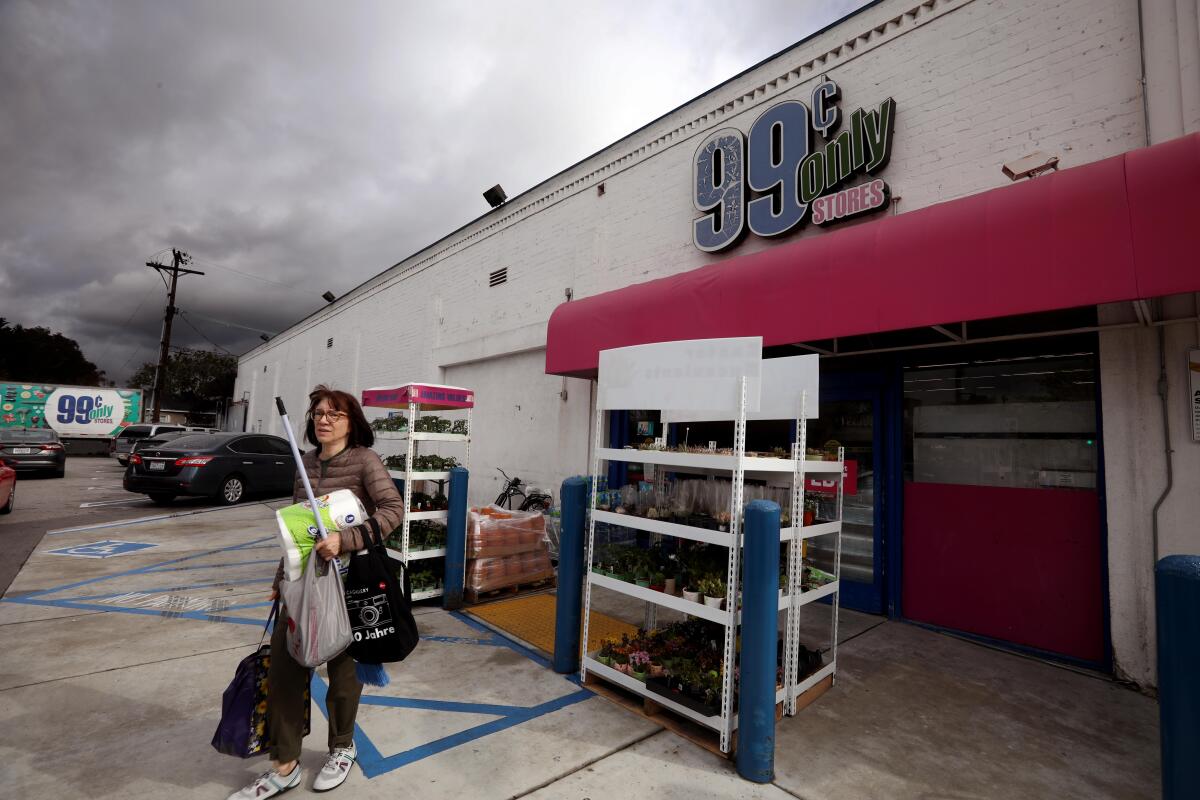 Shoppers walk through the parking lot of a 