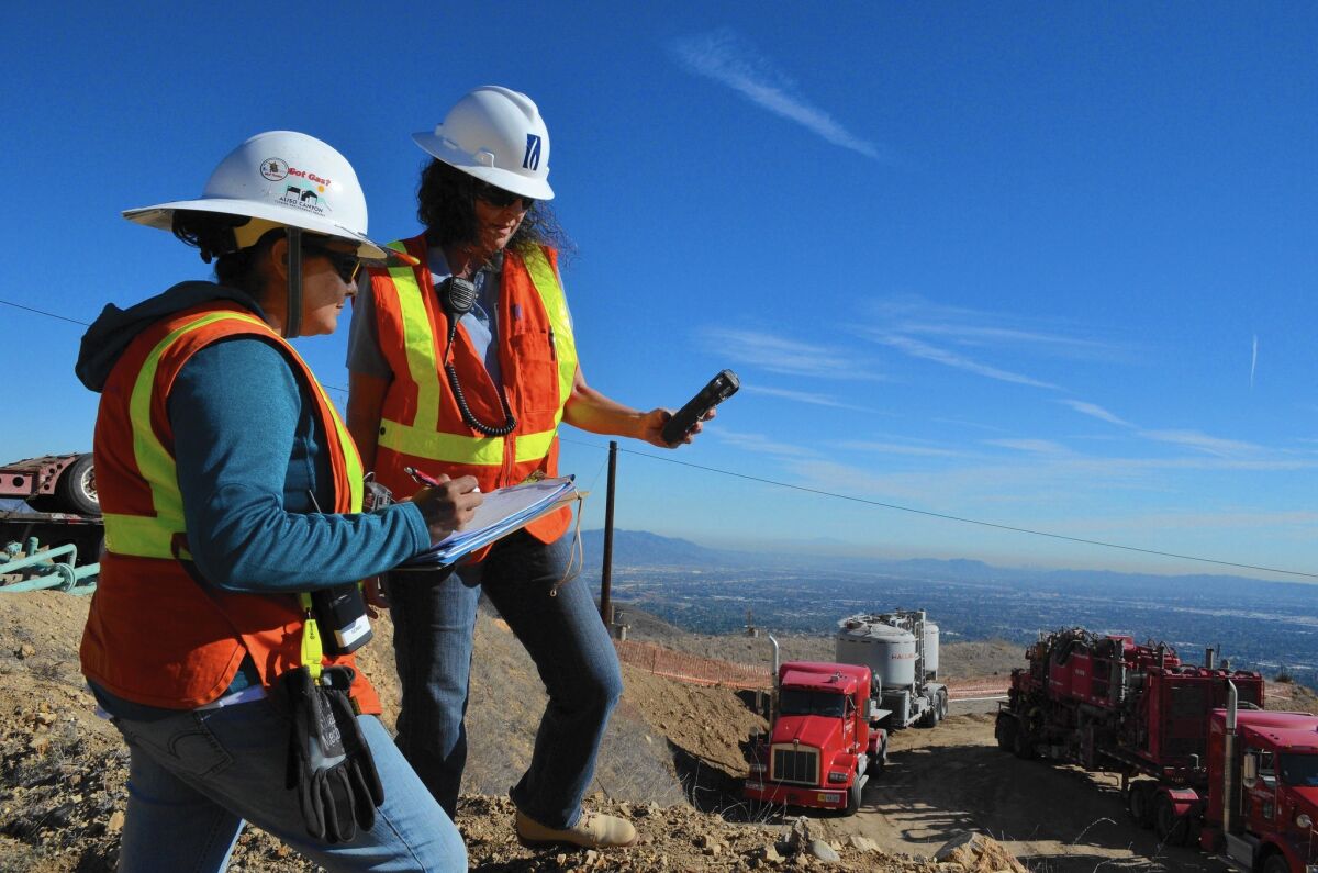 Sonia Rodriguez, left, and Bonnie Feemster take air samples to measure methane leaking from a natural gas pipe near Porter Ranch.
