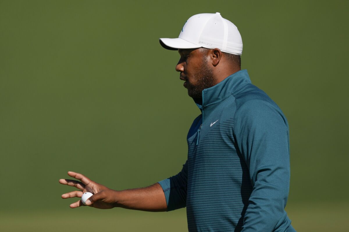 Harold Varner III holds up his ball after a birdie on the second hole during the second round at the Masters golf tournament on Friday, April 8, 2022, in Augusta, Ga. (AP Photo/Matt Slocum)