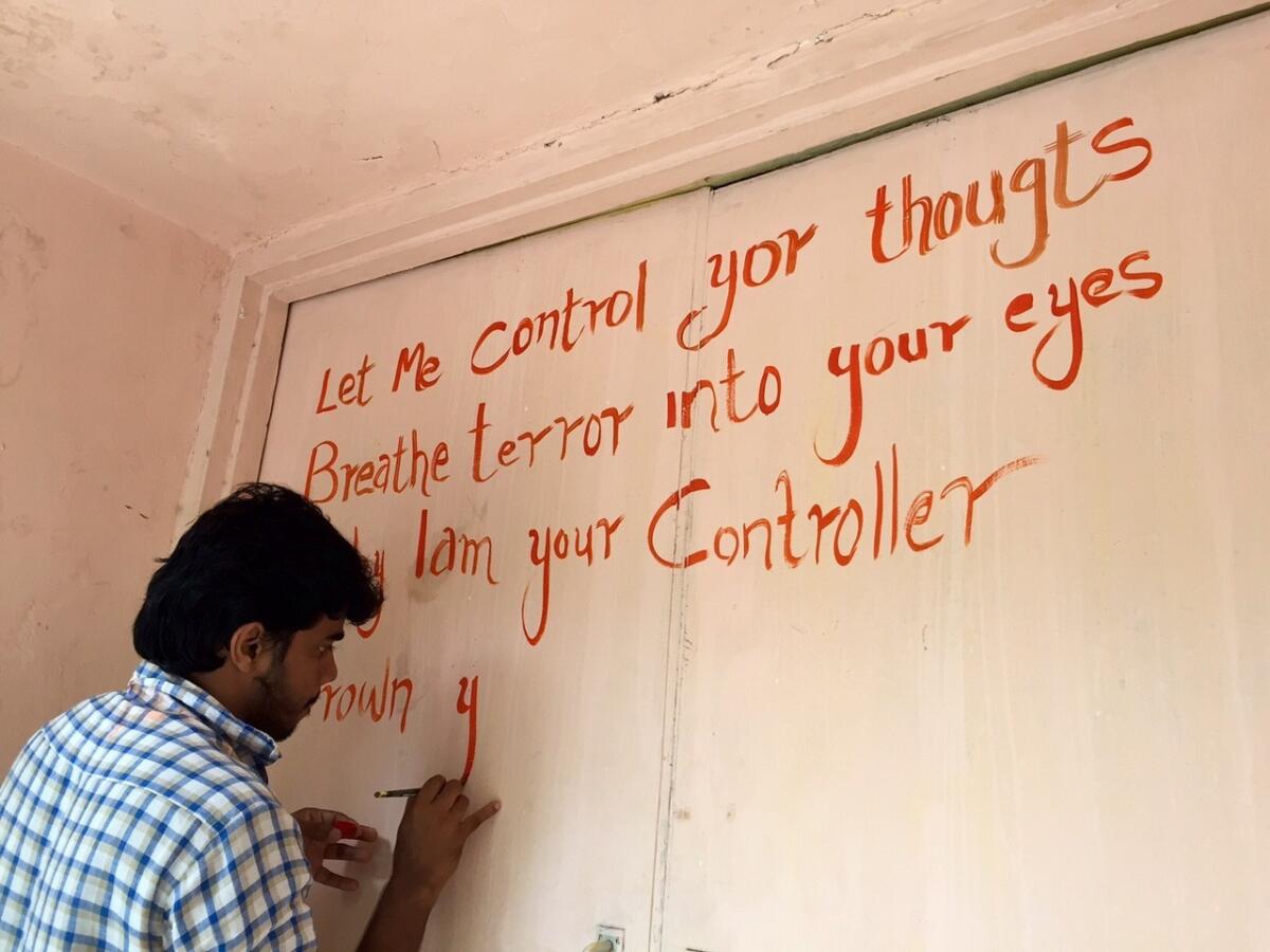 A student paints graffiti on a campus wall at the Film and Television Institute of India in Pune, where students have been on strike for nearly three months.