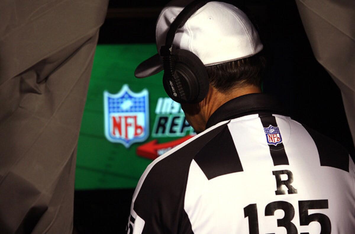 NFL referee Pete Morelli reviews a play during a preseason game between the Dolphins and Chiefs.