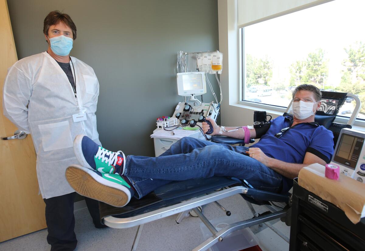 Glenn Walcott, 51 of Newport Beach, right, donated 840ml of plasma to San Diego Blood Bank during a 45-minute session at Hoag Health Center in Irvine on April 28. Phlebotomist Paul Posey, left, from the SDBB helped process the donation.