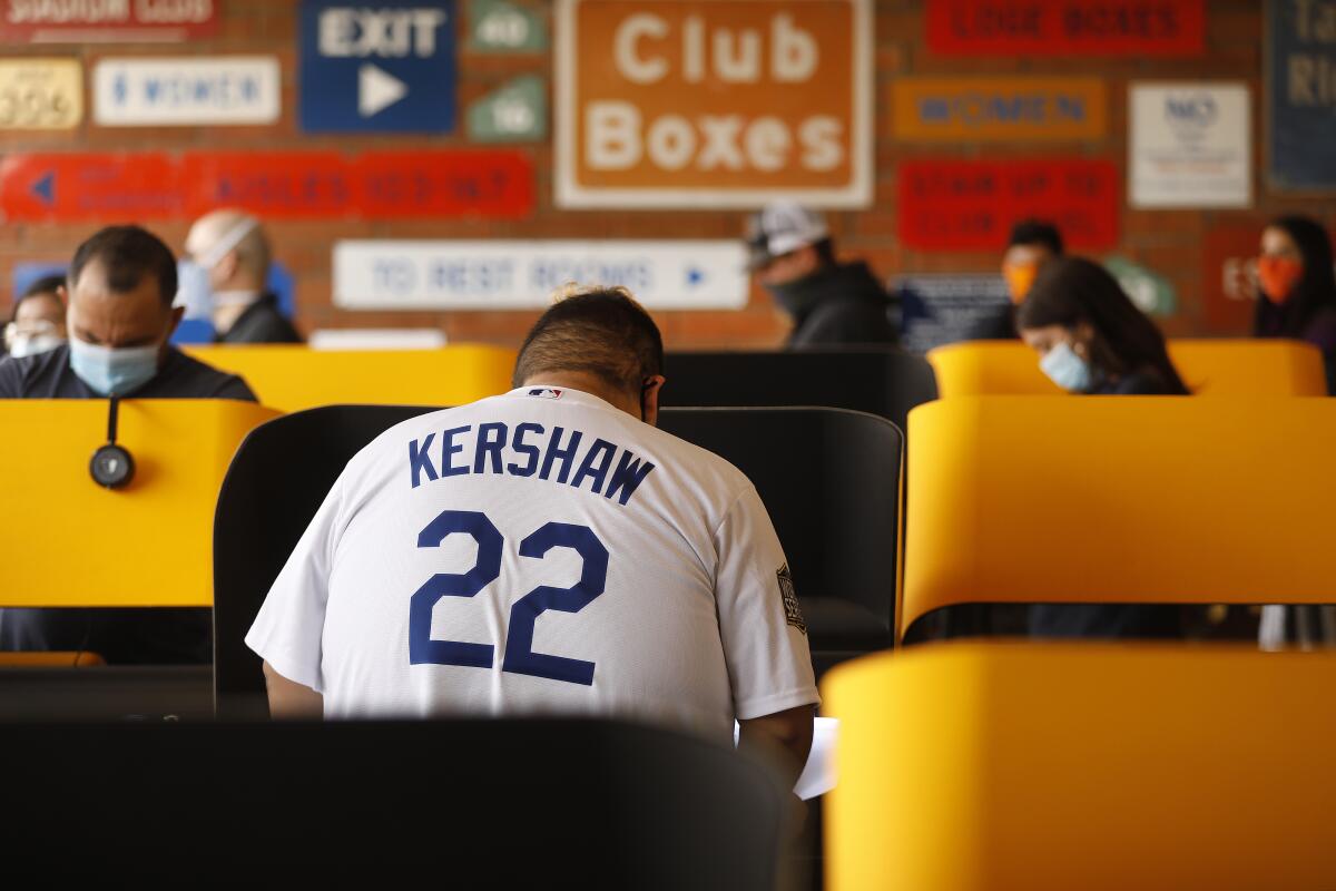 Adam Tapia, 23, wearing his Kershaw jersey, came from Whittier to vote Tuesday at Dodger Stadium in Elysian Park.