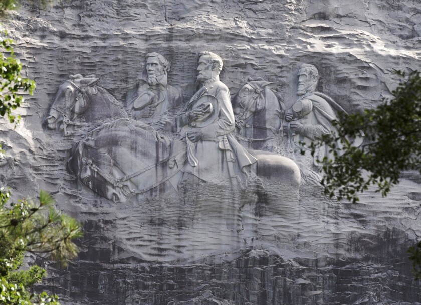FILE - This June 23, 2015 file photo shows a carving depicting Confederate Civil War figures Stonewall Jackson, Robert E. Lee and Jefferson Davis, in Stone Mountain, Ga. The sculpture is America's largest Confederate memorial. (AP Photo/John Bazemore, File)