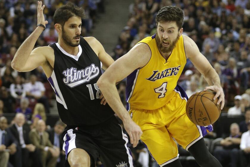 Lakers forward Ryan Kelly drives against Kings forward Omri Casspi during the first half on Monday.