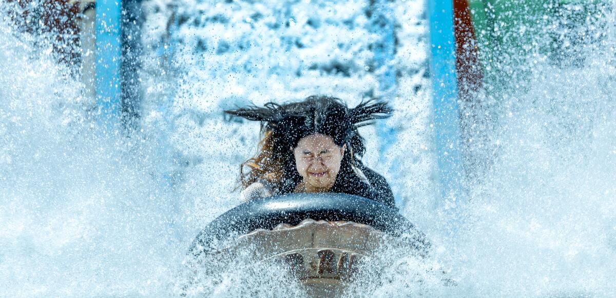 Water sprays a rider on the Wild River ride at the Orange County Fair in Costa Mesa on Friday. 