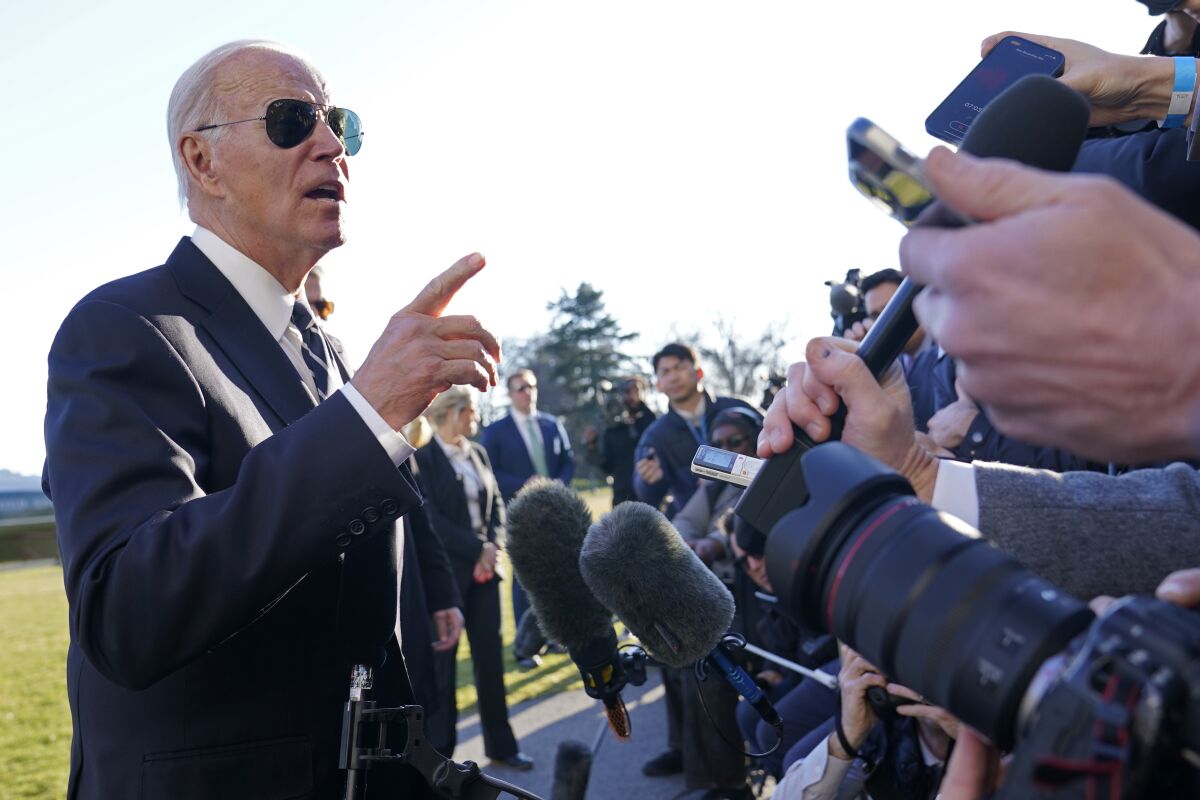 President Joe Biden talks with reporters on the South Lawn of the White House in Washington.