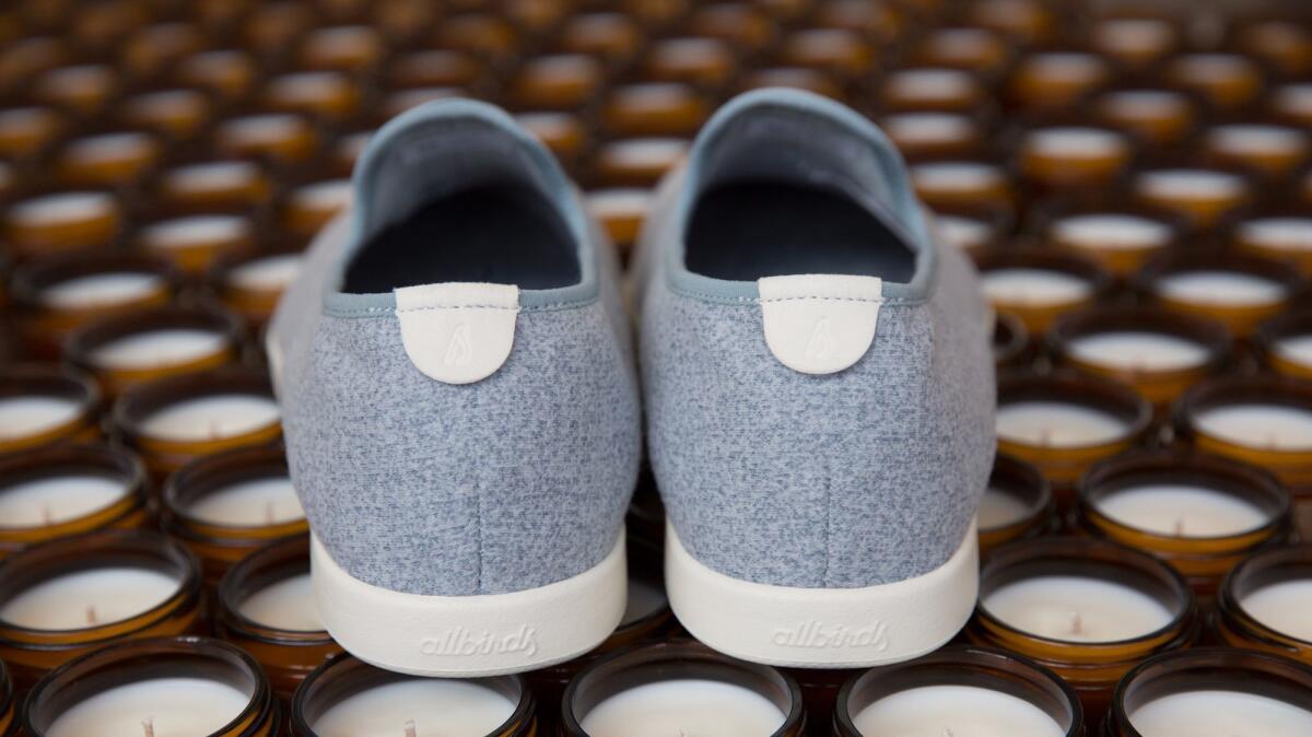 Allbirds and P.F. Candle Co. wool Lounger with off-white sole, $95; and soy candles, which include notes of moss, sweetgrass, vetiver, cedarwood and honey, $18. (Allbirds)