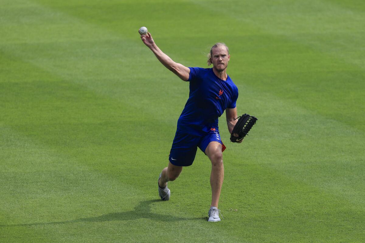 The Mets' Noah Syndergaard throws in the outfield prior to a game against the Reds in Cincinnati