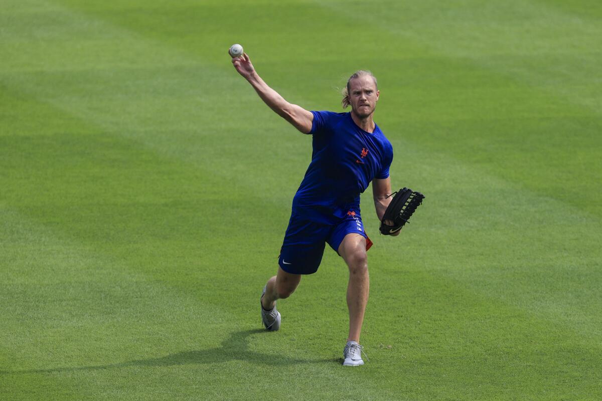 Noah Syndergaard throws in the outfield before a baseball game in Cincinnati.