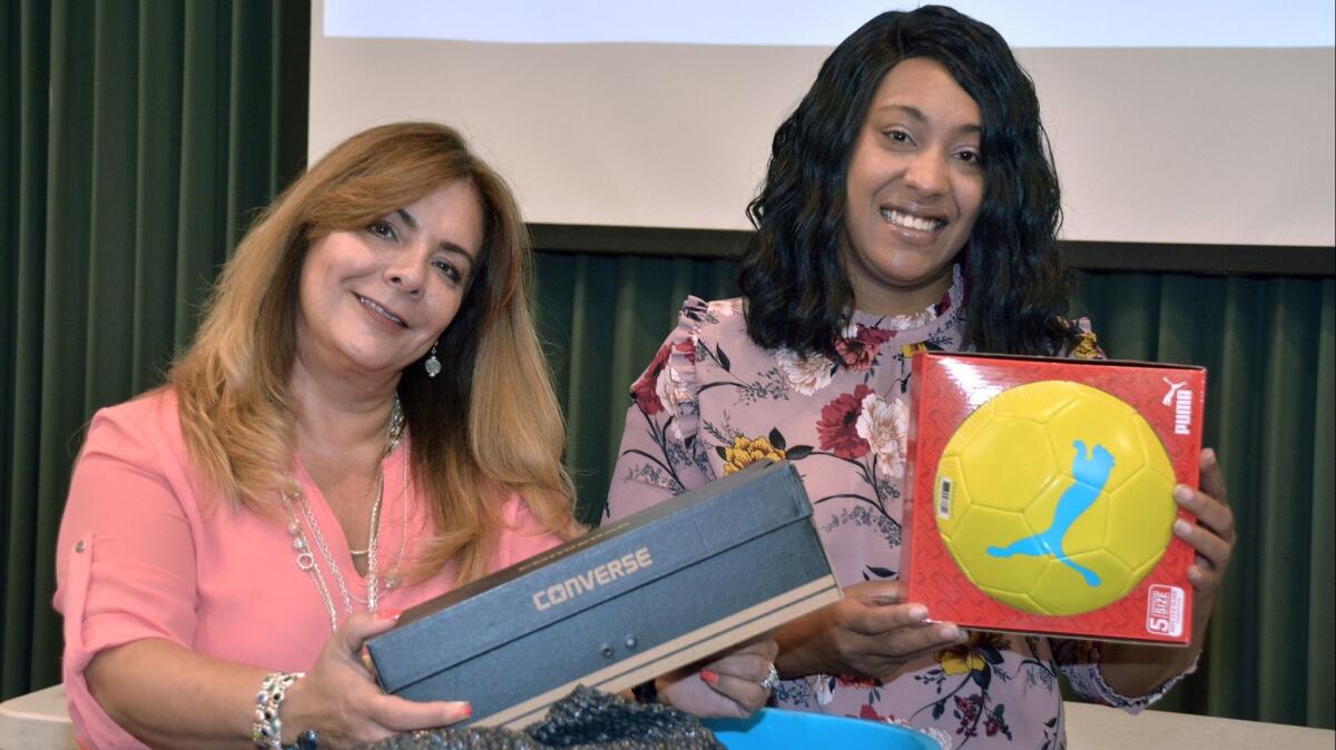 Collecting items for the local Boys and Girls Club, Media West Realty Realtor Marty Rocio Del Cid, left, joined forces with BAOR Executive Director Cheritta Smith to ensure the success of last week's Donation Fair.