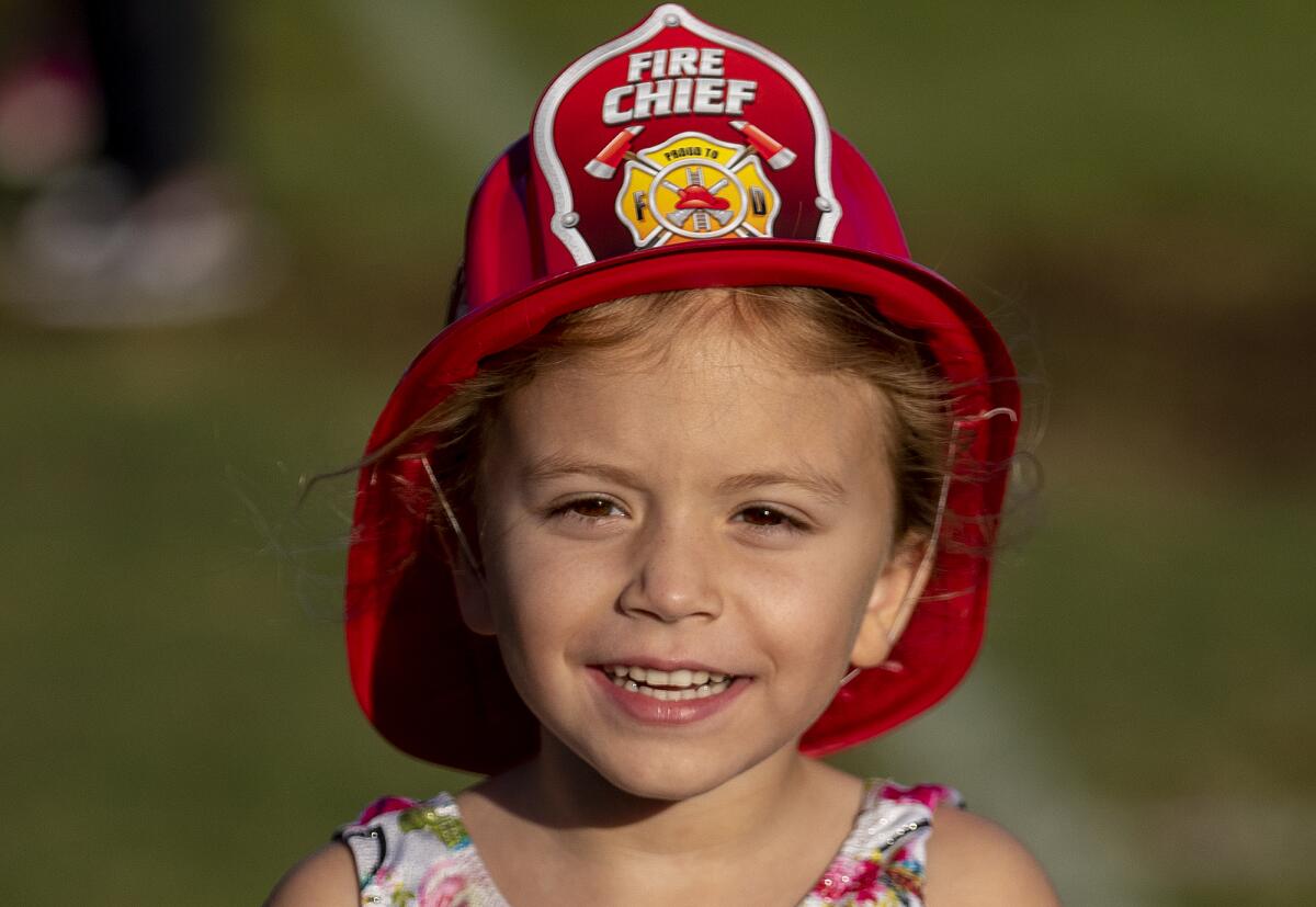  Everly Green, 5, wears a fire chief hat during the National Night Out event on Tuesday.