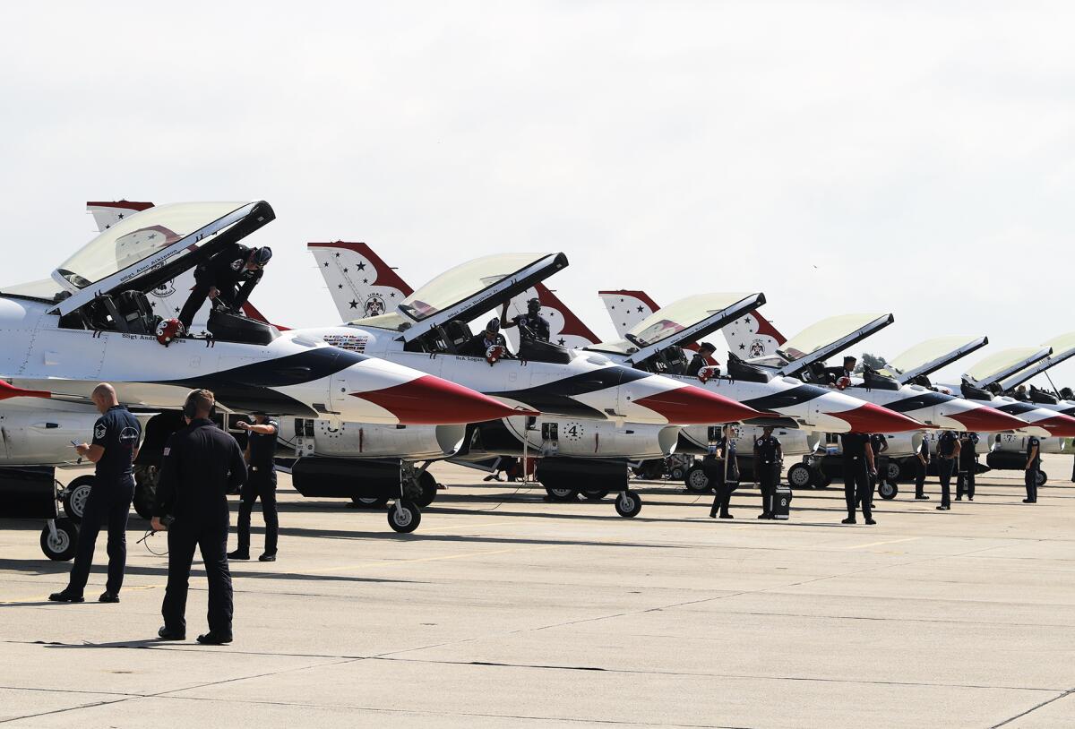 U.S. Air Force Thunderbirds pilots step into their aircraft for a test flight during the Pacific Air Show preview Thursday.