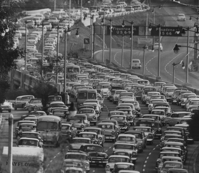 Single-arm pendant electroliers watch over rush-hour traffic on the southbound Pasadena Freeway in 1956.