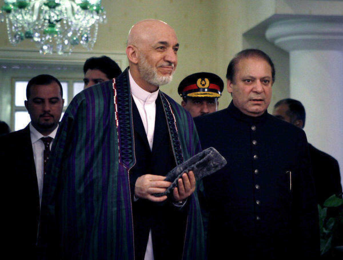 Afghan President Hamid Karzai, center left, and Pakistani Prime Minister Nawaz Sharif, right, arrive Monday for a meeting in Islamabad, Pakistan.