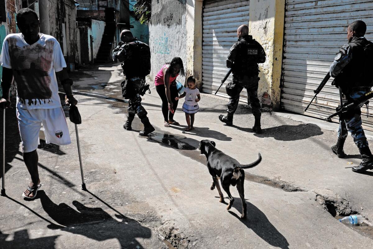Police patrol a shantytown in Rio de Janeiro. The number of killings in Brazil has dropped in larger, more affluent cities such as Rio but jumped in poorer areas.