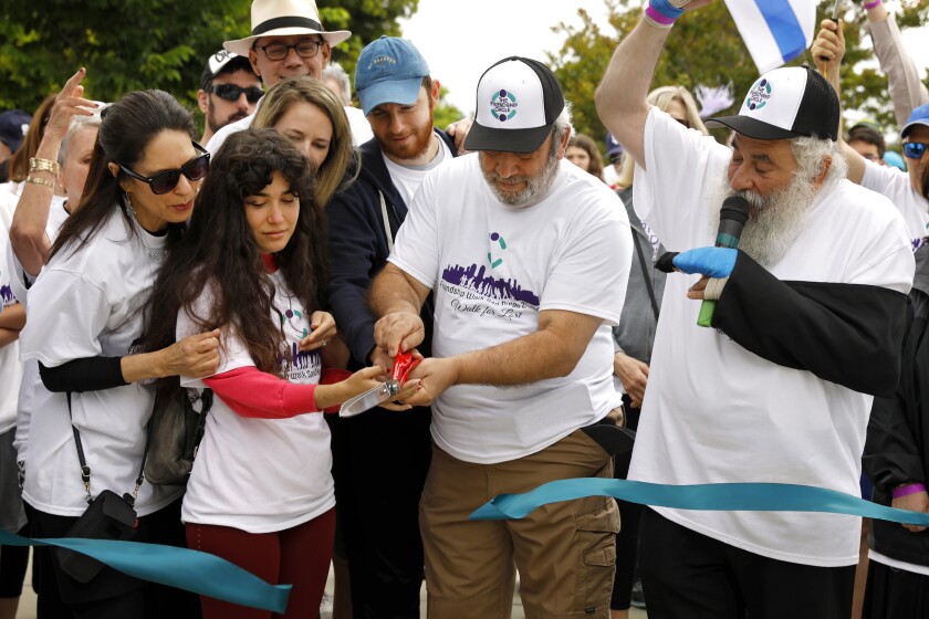 The annual Friendship Walk honored Lori Gilbert-Kaye, who was shot and killed while attending Passover service at Chabad of Poway. Members of her family cut the starting line ribbon before the walk. From left to right, her sister, Randi Grossman, Lori's daughter Hannah Kay, niece Alex Grossman and her husband, Alex Vaysburd and Lori's husband, Dr. Howard Kaye.