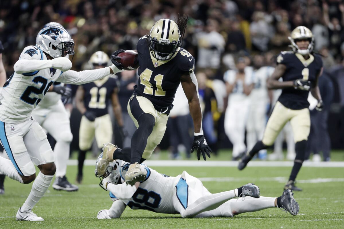 New Orleans Saints running back Alvin Kamara carries the ball against the Carolina Panthers.