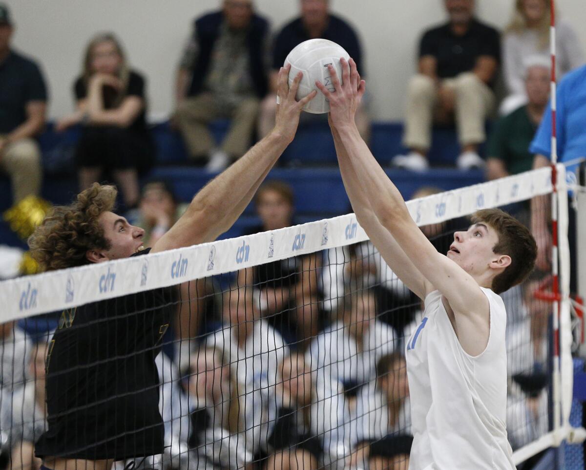 Edison's Owen Banner and Ryan Gant, from left, joust at the net during a CIF Division 1 boys' volleyball match.