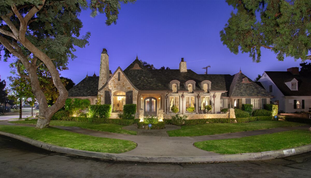 Set on a quarter of an acre, the custom home features French Normandy vibes with a stone exterior and steep pitched roof.