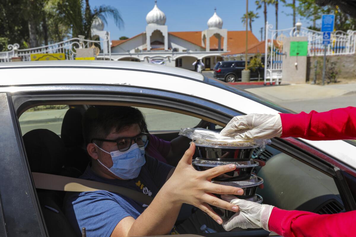 Meals are delivered to drive-through participants during the event.