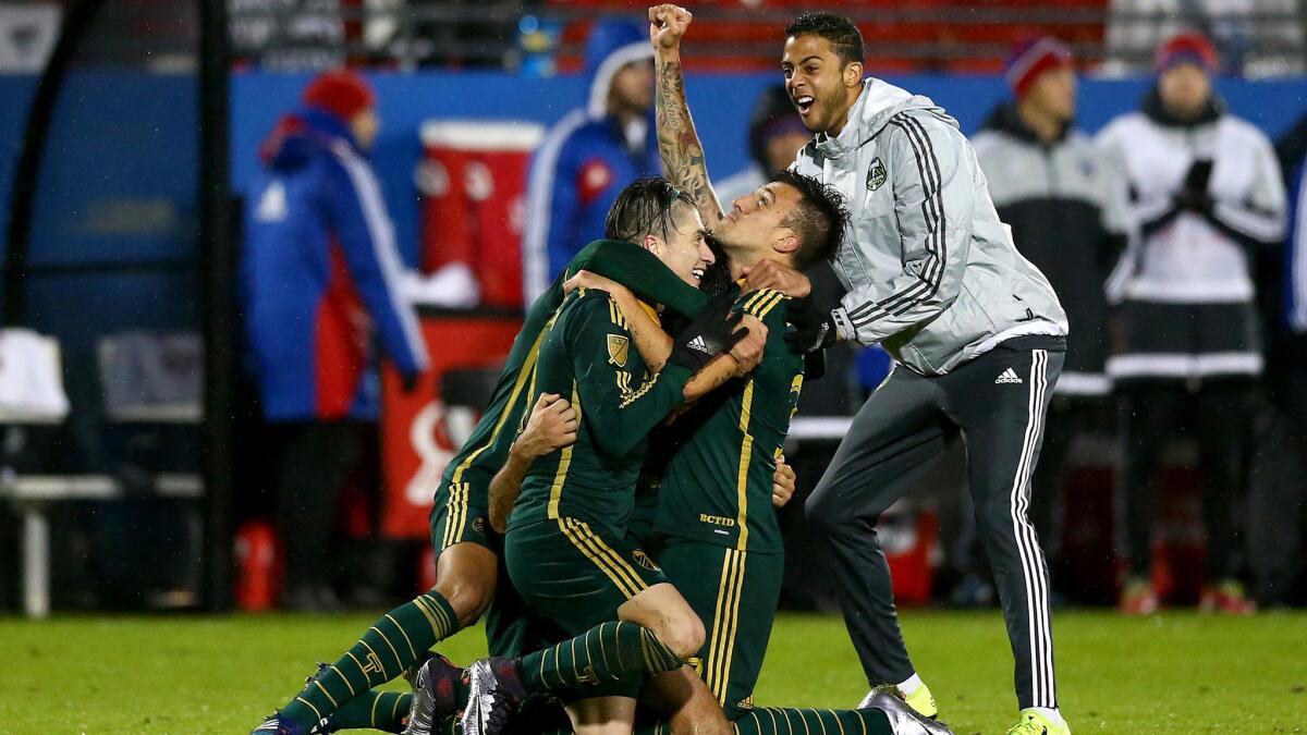 Timbers forward Maximiliano Urruti, center, celebrates with teammates after eliminating FC Dallas and earning a spot in the MLS Cup.