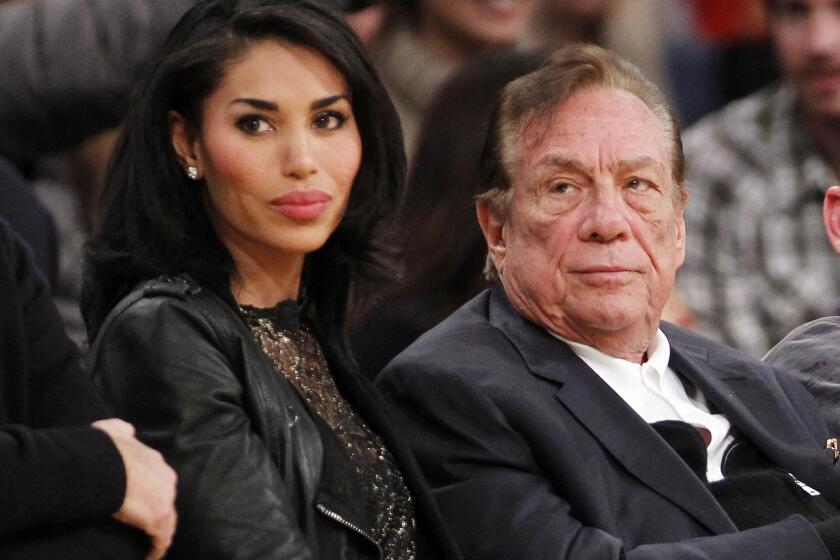 Los Angeles Clippers owner Donald Sterling, right, and V. Stiviano, left, watch the Clippers play the Los Angeles Lakers last December