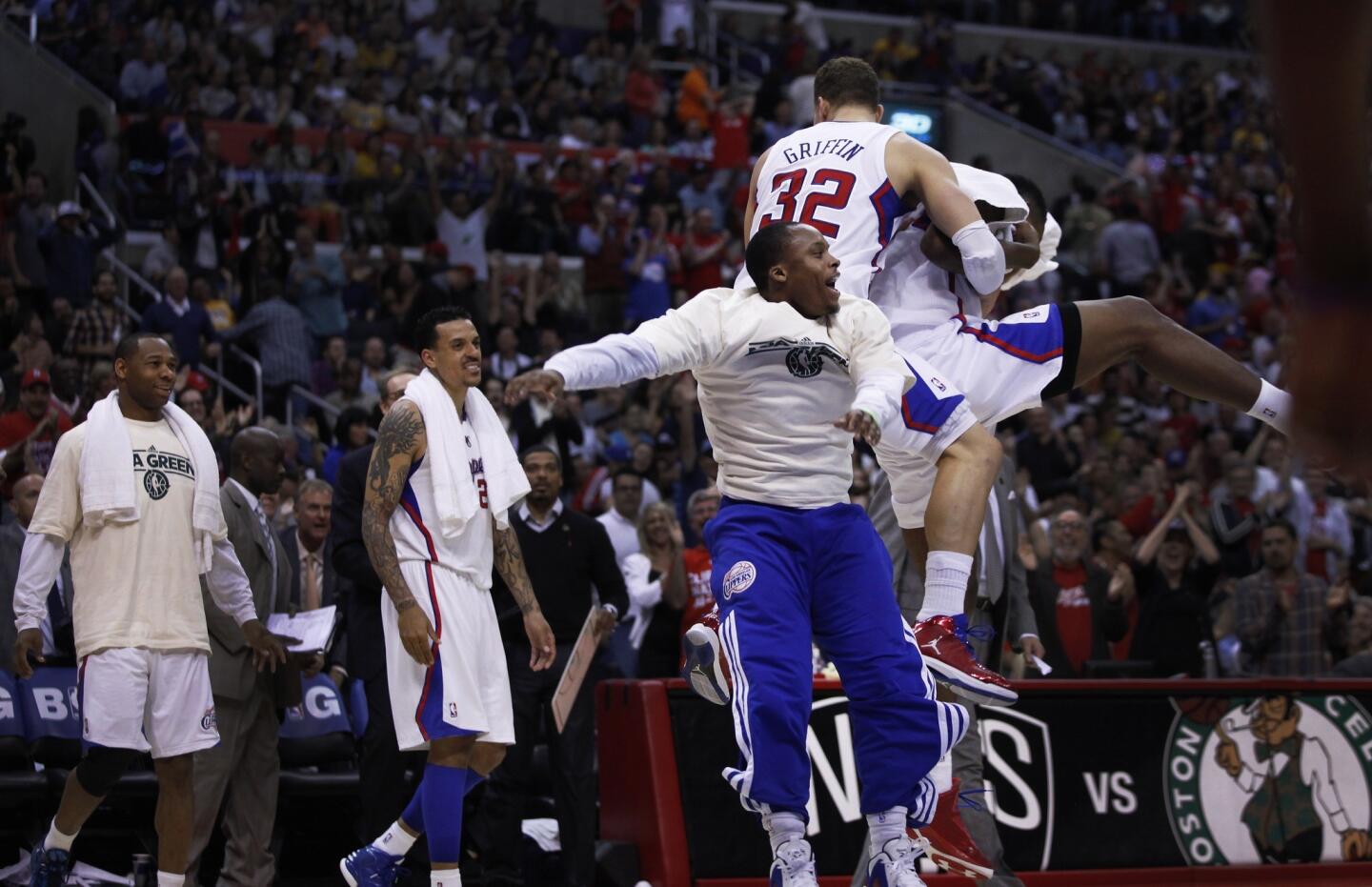 Clippers players celebrate in the final moments of their 109-95 victory over the Lakers on Sunday afternoon at Staples Center.