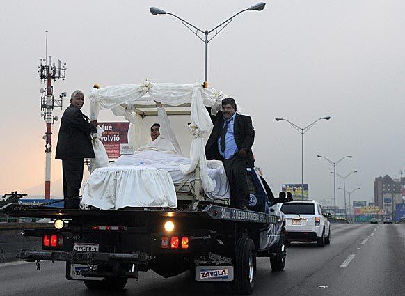 Manuel "Meme" Uribe, 43, center, is driven in a forklift to the dance hall where he and Claudia Solis will get married in Monterrey, Mexico, Sunday, Oct. 26, 2008. Uribe, who tipped the scales in 2006 at 1,230 pounds (560 kilograms), earning him the Guinness Book of World Records' title for the world's heaviest man, lost 550 pounds (250 kilograms) with the help of Solis, whom he met four years ago.