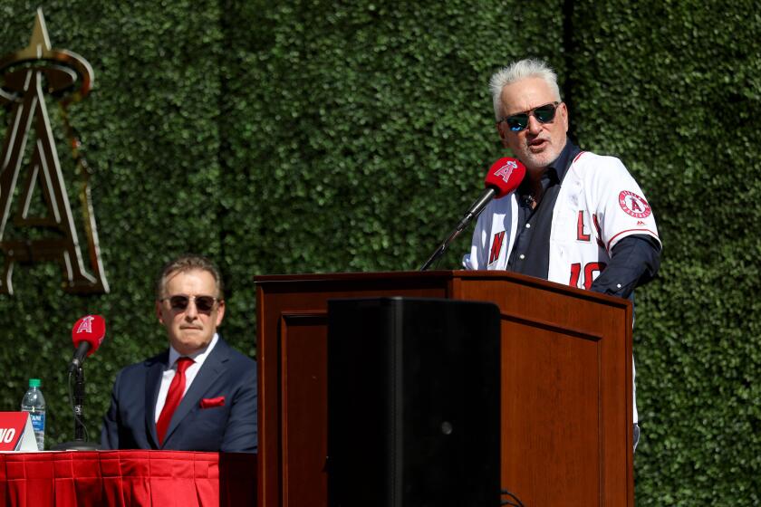 ANAHEIM, CALIF. -- THURSDAY, OCTOBER 24, 2019: The Los Angeles Angels of Anaheim introduce Joe Maddon, right, shown with Owner Arte Moreno, as latest manager of the team at a press conference held at Angel Stadium in Anaheim, Calif., on Oct. 24, 2019. (Gary Coronado / Los Angeles Times)