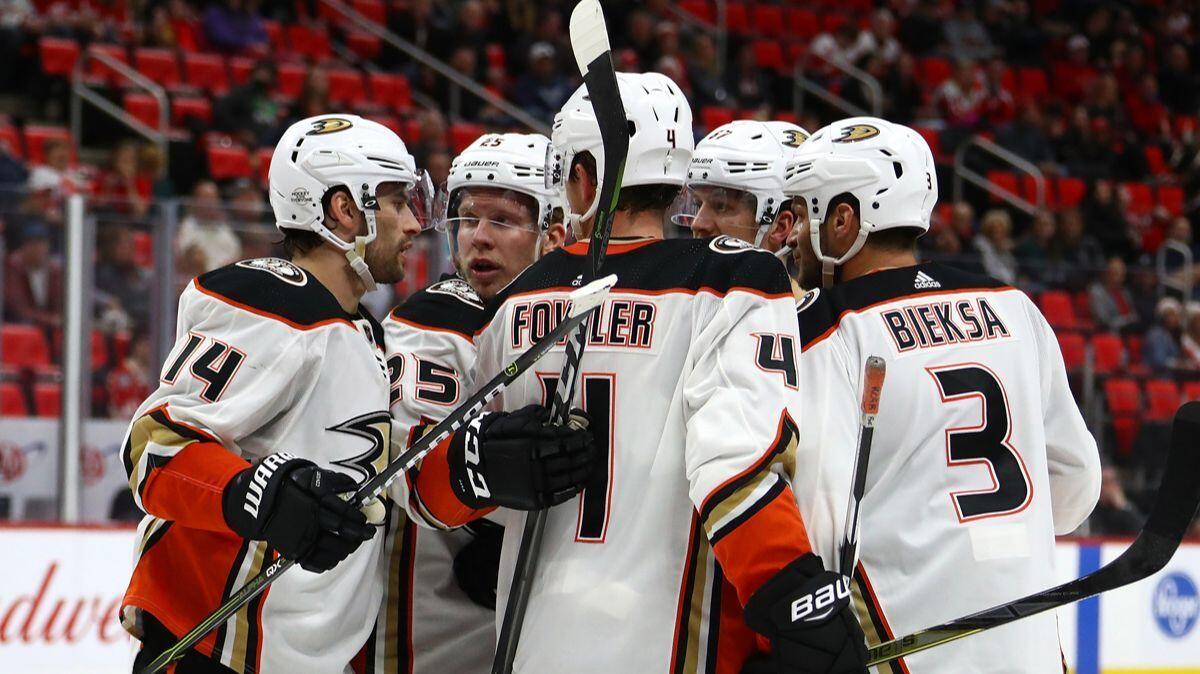 Ducks' Adam Henrique (14) celebrates his goal with teammates while playing the Detroit Red Wings on Tuesday.
