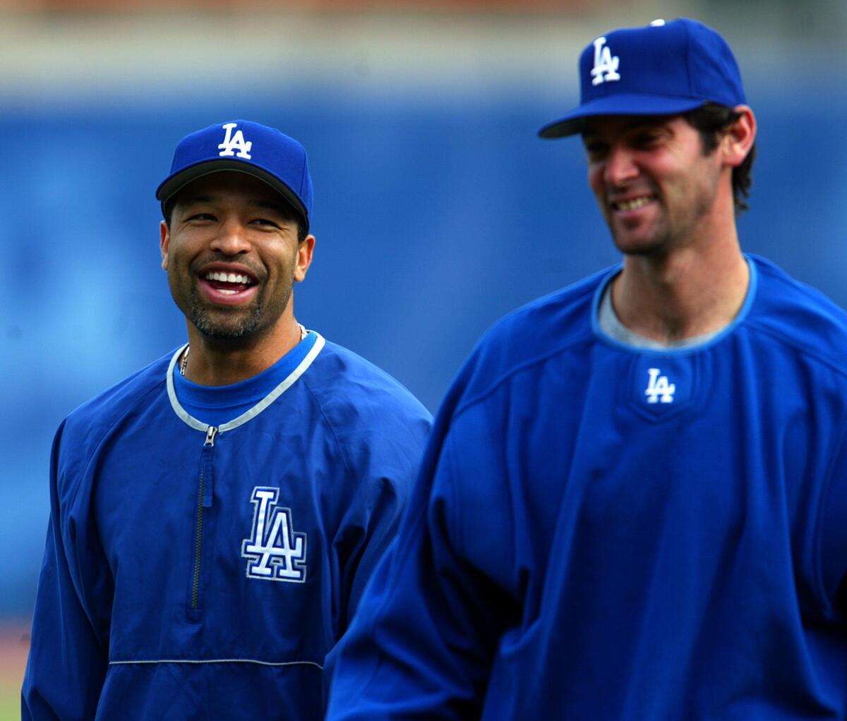 Dave Roberts, left, and Shawn Green share a laugh prior to the Dodgers' first winter workout in 2004.