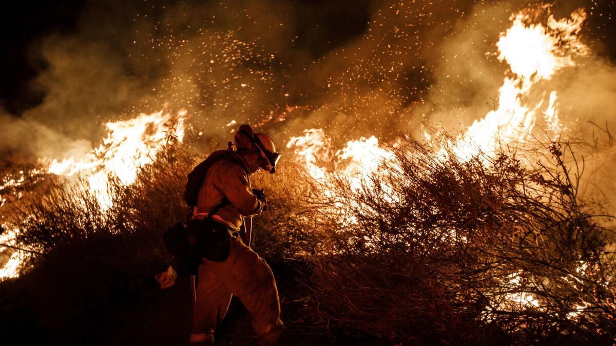 A firefighter conducts a burn operation to remove fuel around homes as the Holy fire burned near Lake Elsinore, Calif., last year.