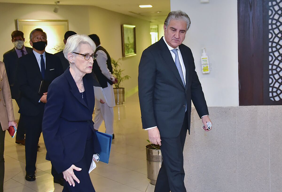 In this photo released by Pakistan's Ministry of Foreign Affairs, visiting U.S. Deputy Secretary of State Wendy Sherman, left, and Pakistan's Foreign Minister Shah Mahmood Qureshi, right, walk towards a meeting room at the Ministry of Foreign Affairs in Islamabad, Pakistan, Friday, Oct. 8, 2021. Sherman was meeting senior Pakistani officials Friday amid a worsening relationship between the two countries as each tries to navigate a way forward in Afghanistan under Taliban rule. (Ministry of Foreign Affairs vis AP)