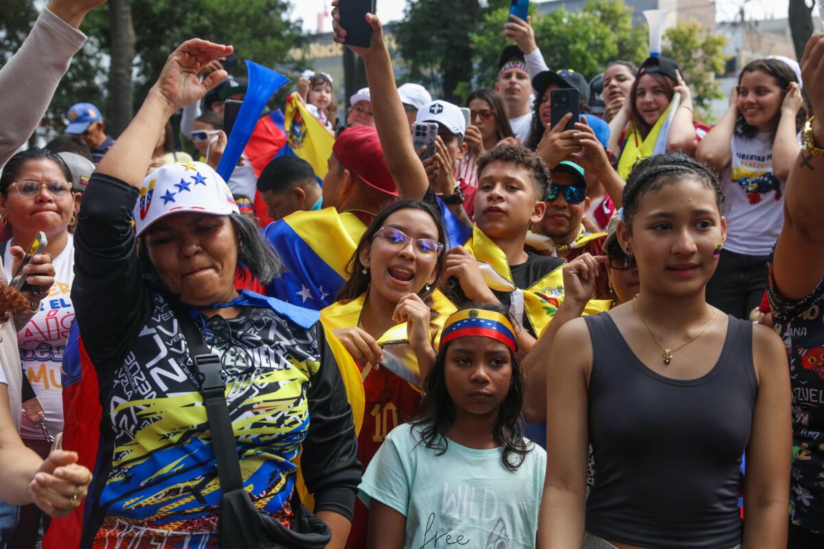 Venezuelan citizens in Peru celebrate during a rally