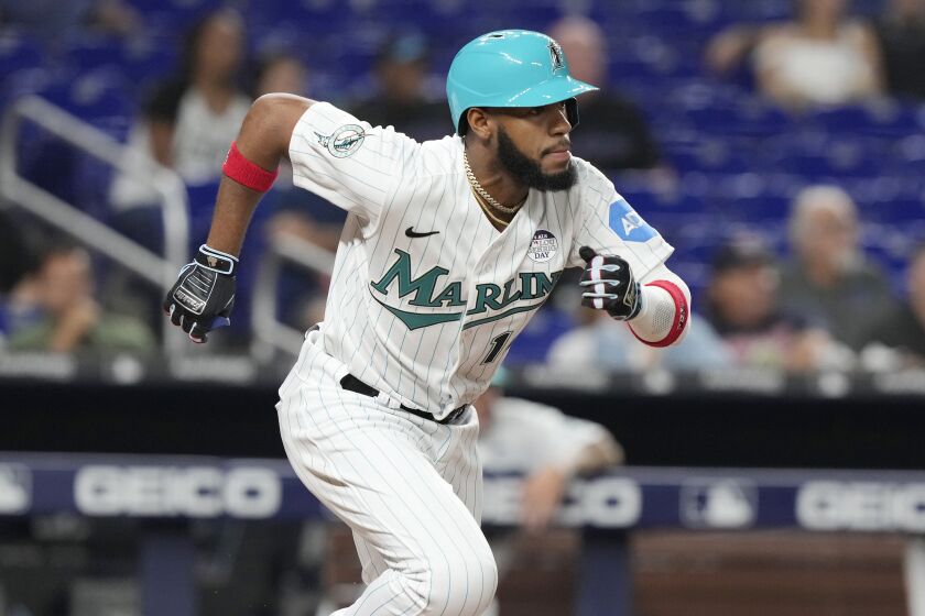 Miami Marlins' Bryan De La Cruz (14) singles to right field during the fifth inning of a baseball game against the Oakland Athletics, Friday, June 2, 2023, in Miami. (AP Photo/Marta Lavandier)