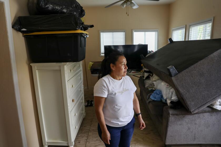 SAN DIEGO, CA-MAY 10: Marcela Ralac stands in her home, which is still under repair, in Southeast San Diego on Friday, May 10, 2024.(Photo by Sandy Huffaker for The SD Union-Tribune)