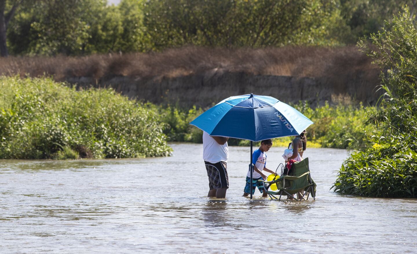 A family cools off in the Santa Ana river