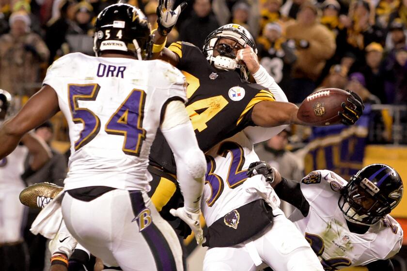 Steelers receiver Antonio Brown (84) reaches the ball across the goal line for what proved to be the game-winning touchdown against the Ravens Sunday.