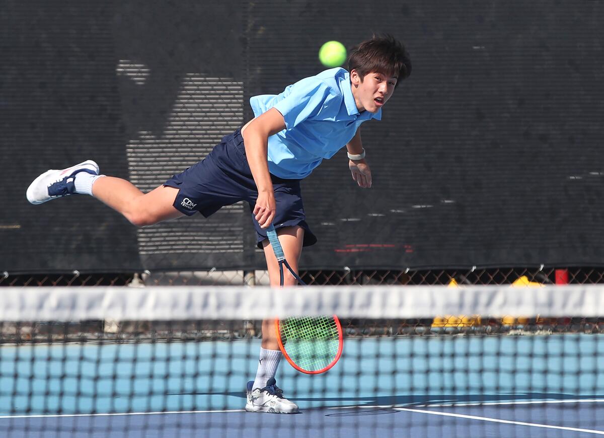 CdM doubles player Tristan Pham hits a serve against Woodbridge on Wednesday.