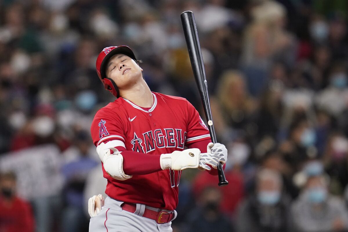 Los Angeles Angels' Shohei Ohtani reacts after striking out swinging to end then top of the seventh inning of a baseball game against the Seattle Mariners, Sunday, Oct. 3, 2021, in Seattle. (AP Photo/Elaine Thompson)